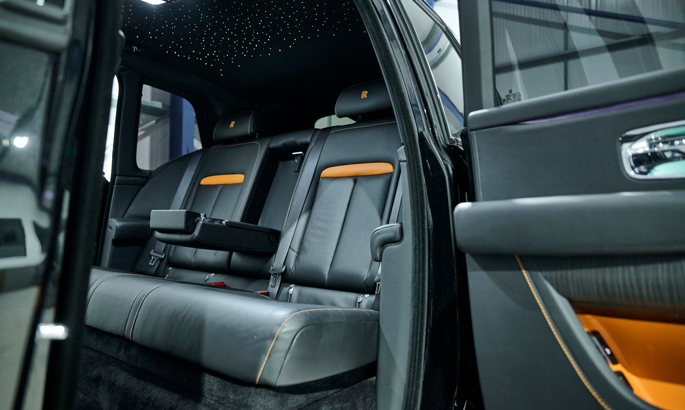 Luxury car interior with gray seats and orange accents