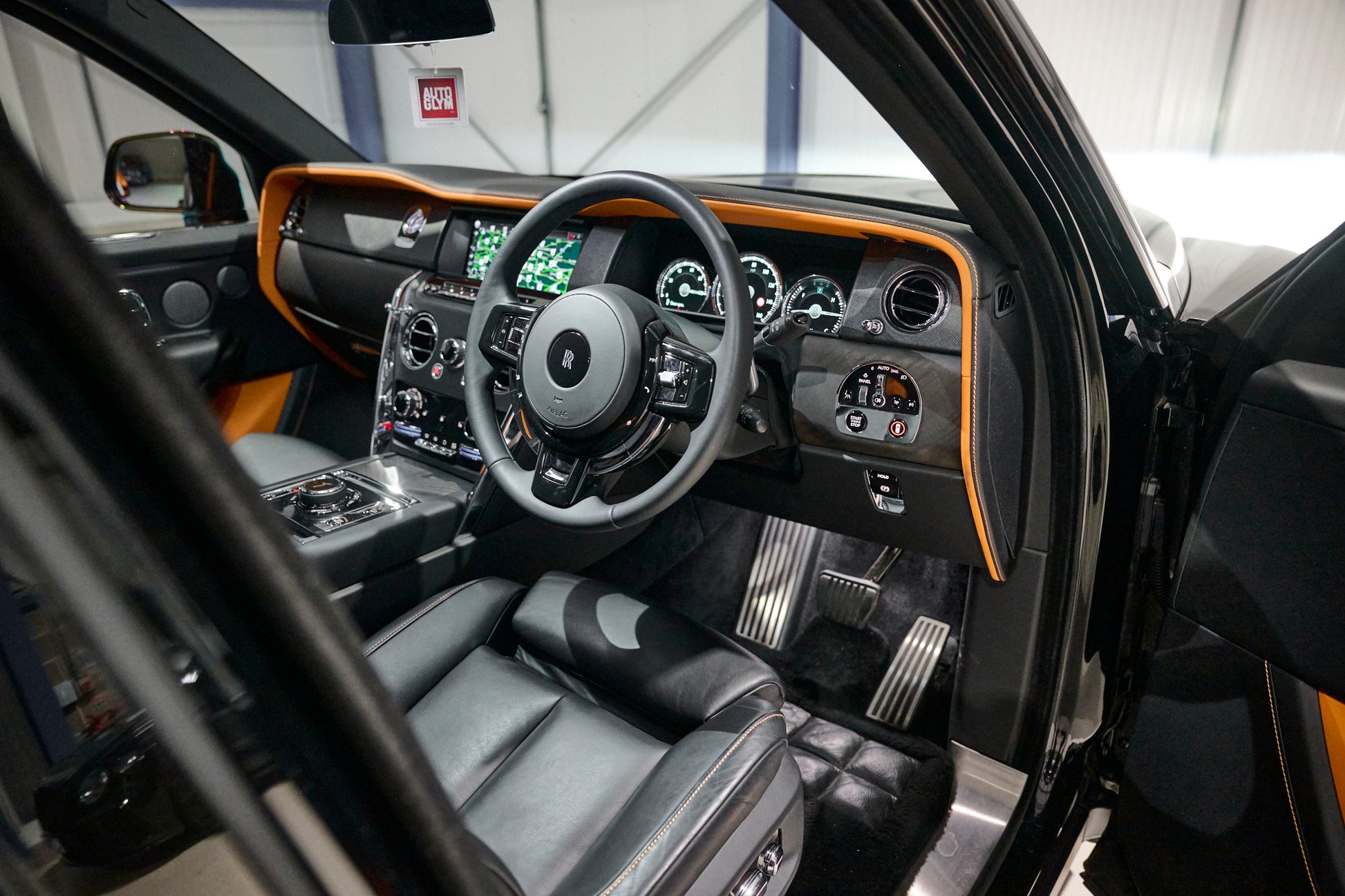 Luxury car interior with steering wheel and dashboard