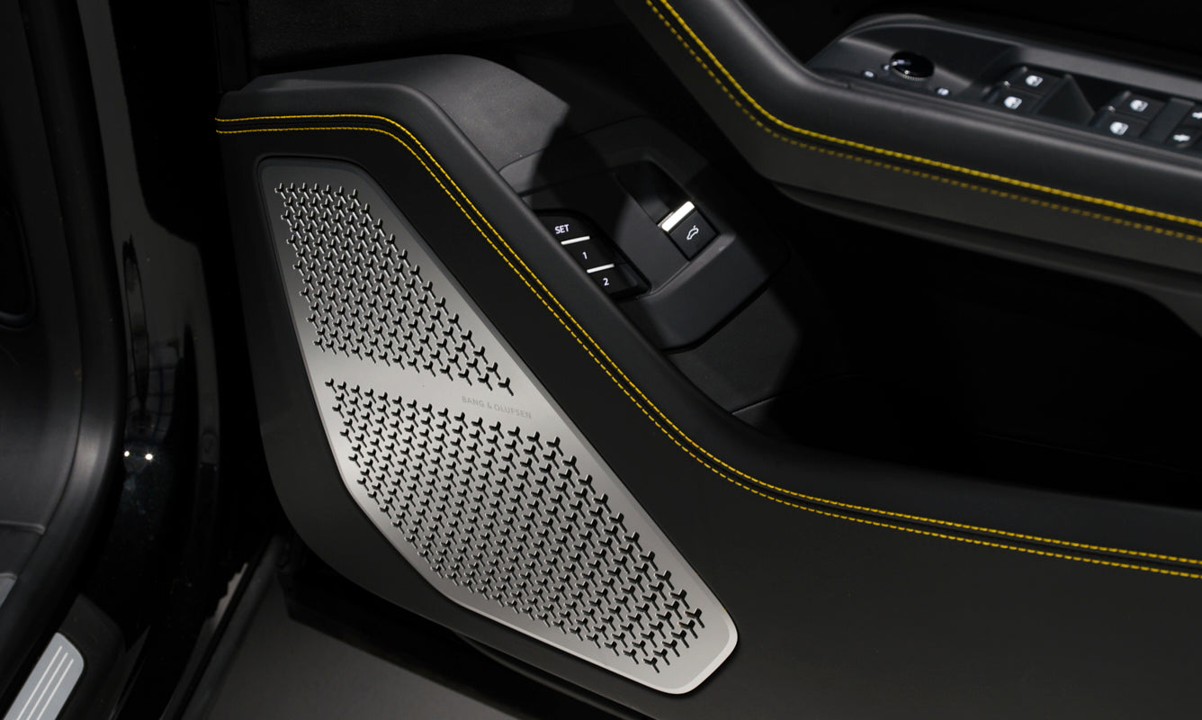 Close-up of a car door panel with textured black and yellow accents