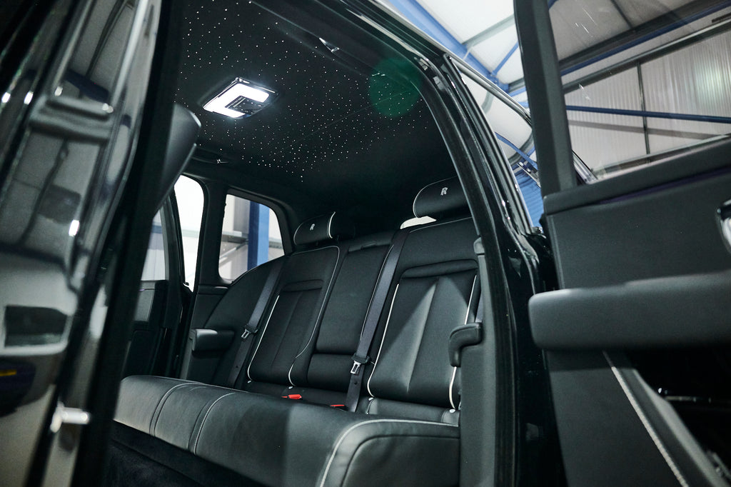 Back seat of a vehicle with open door, interior view